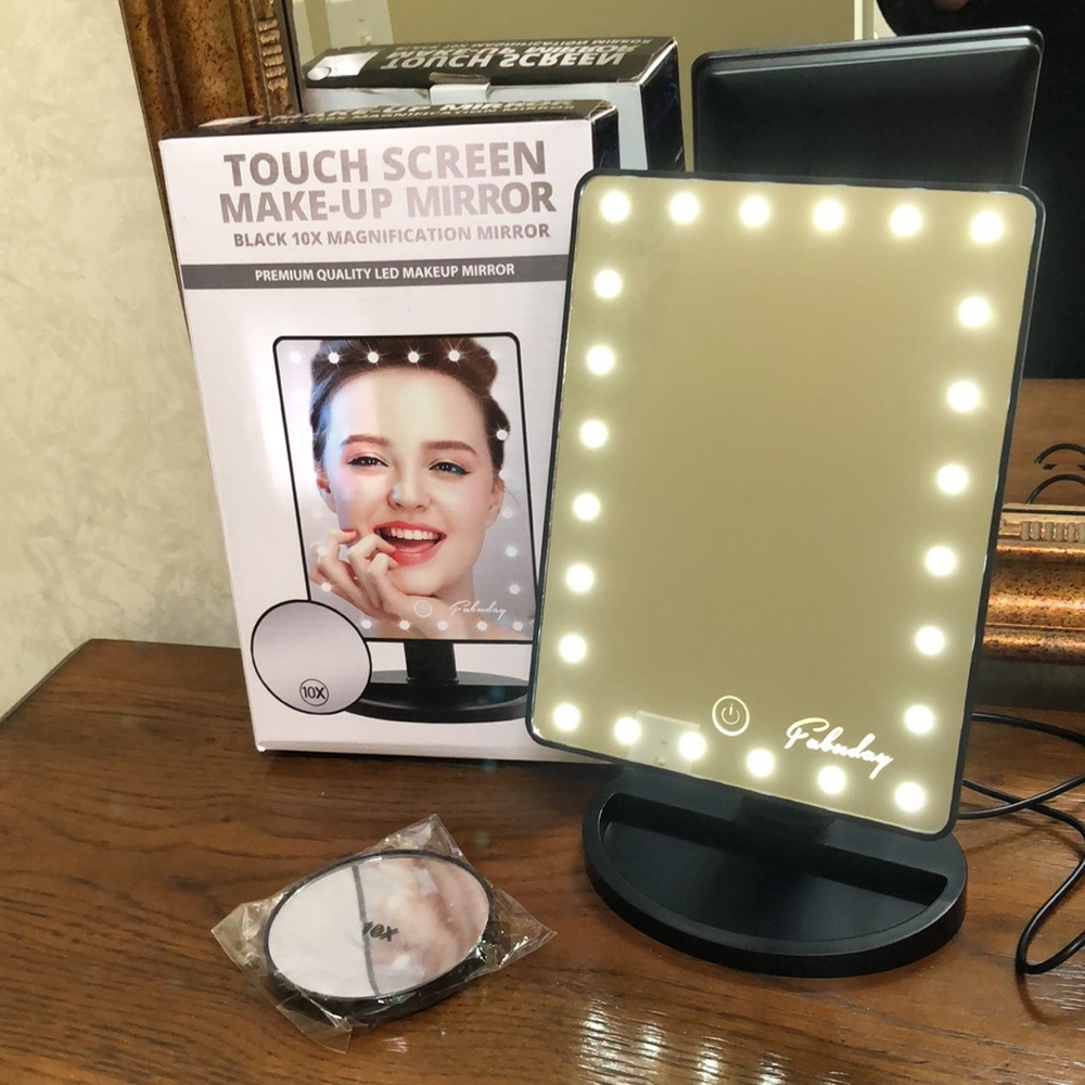 New touch screen makeup mirror with small 10X attachable mirror. 24 led lights.